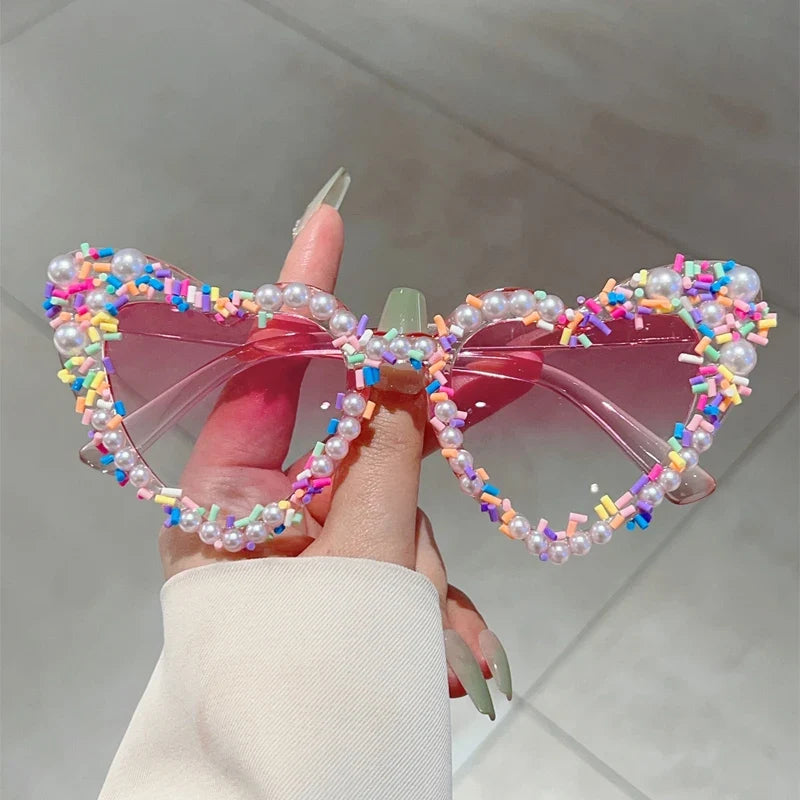 Pink pearl-embellished heart-shaped sunglasses with colourful beading